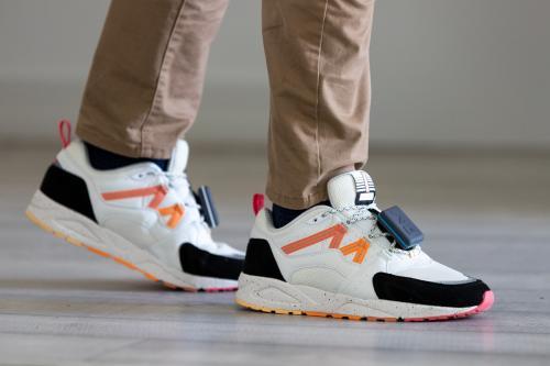 Person wearing shoes with REEV's device attached.