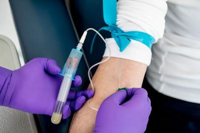 Phlebotomist taking blood from a patient's arm