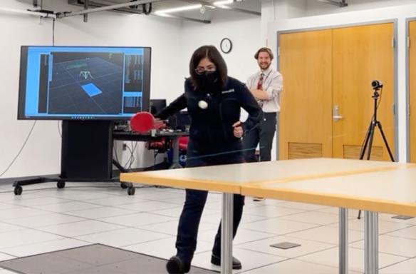 Woman playing ping-pong in a motion capture lab