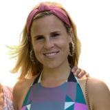 Libby outside with a sunny background.